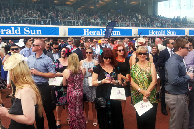 Ladies and gentlemen dress up at Caulfield Cup