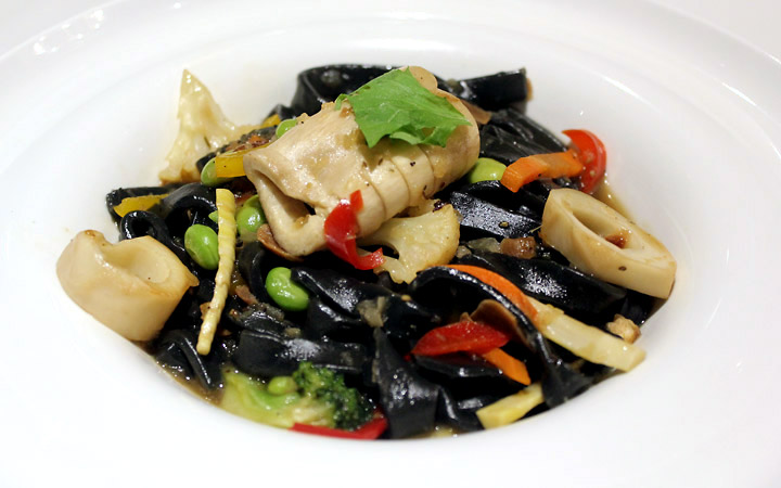 Vegetarian mock calamari and black linguini.